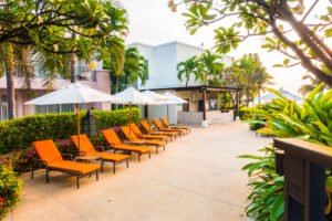 Empty Umbrella and chair around swimming pool in hotel resort